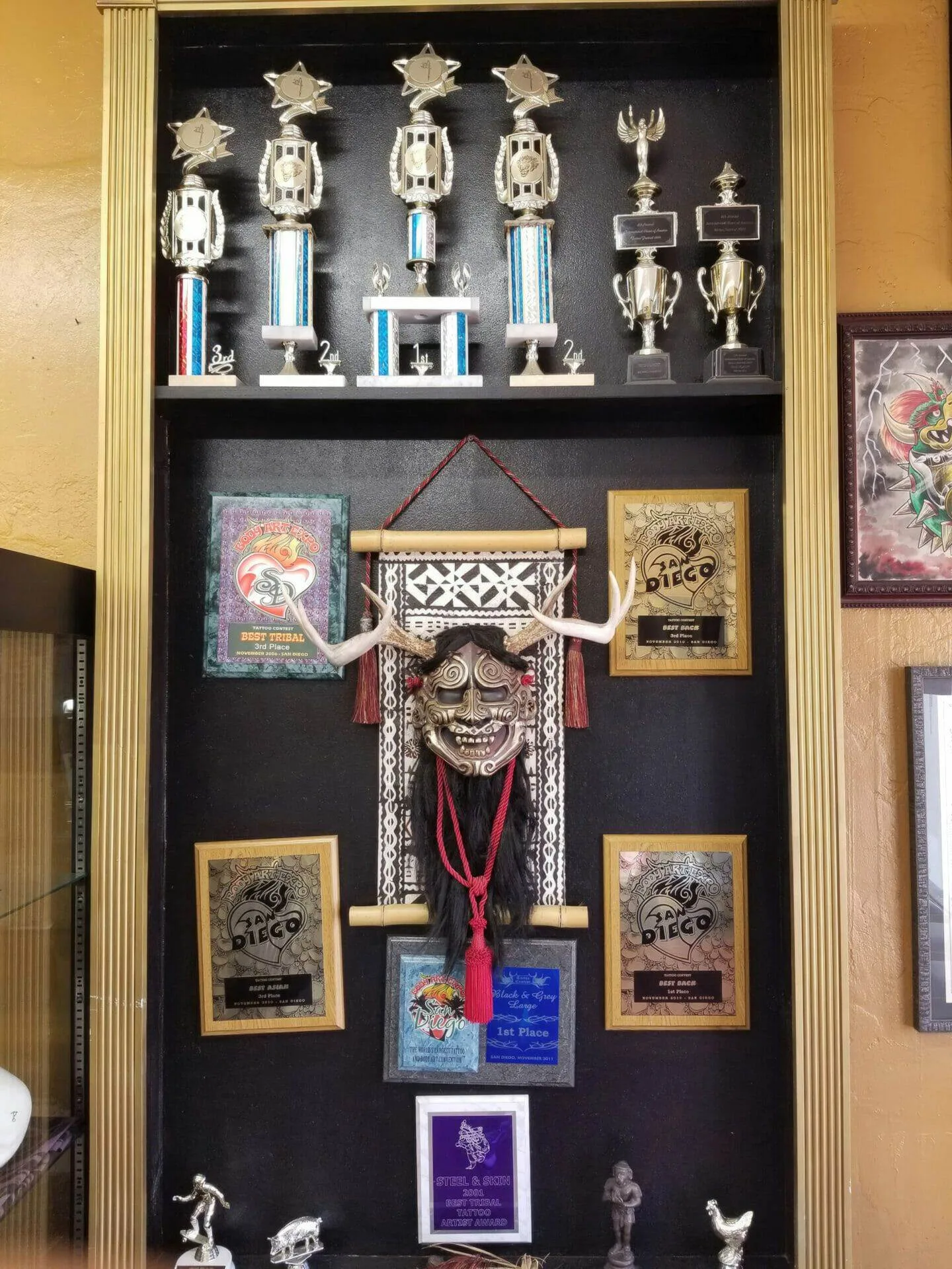Award trophies and plaques at Funhouse Tattoo
